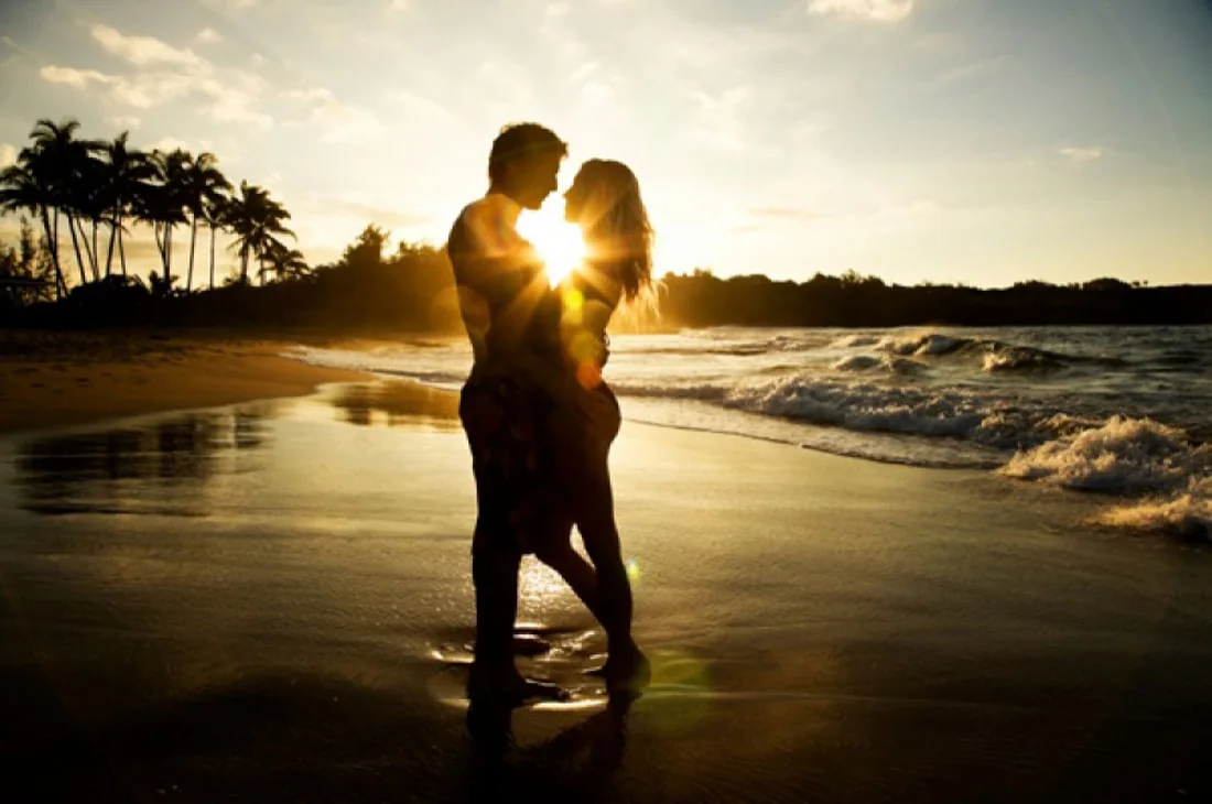 A couple embracing on the beach at sunset